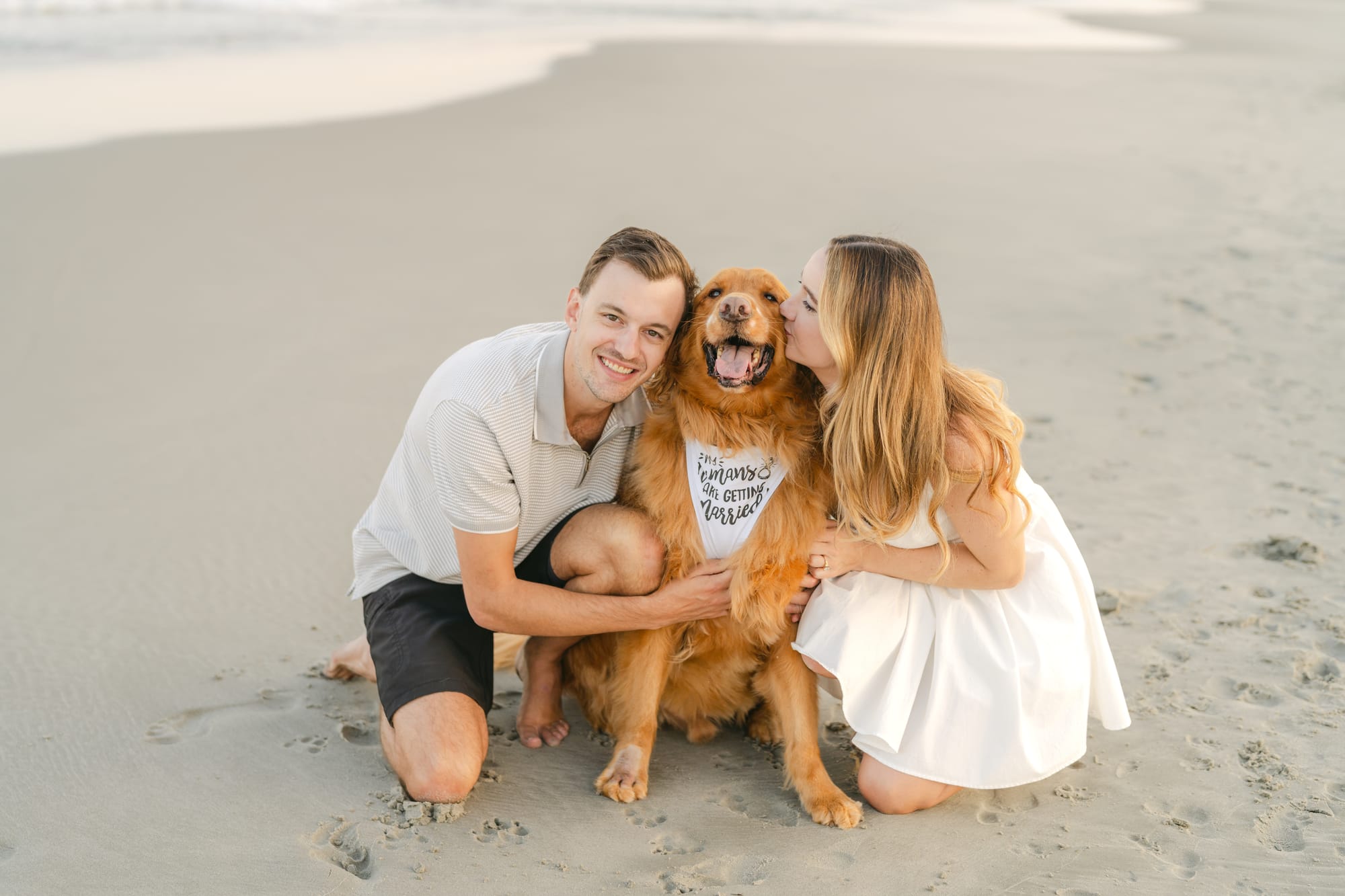 Sharing a kiss over the golden retriever
