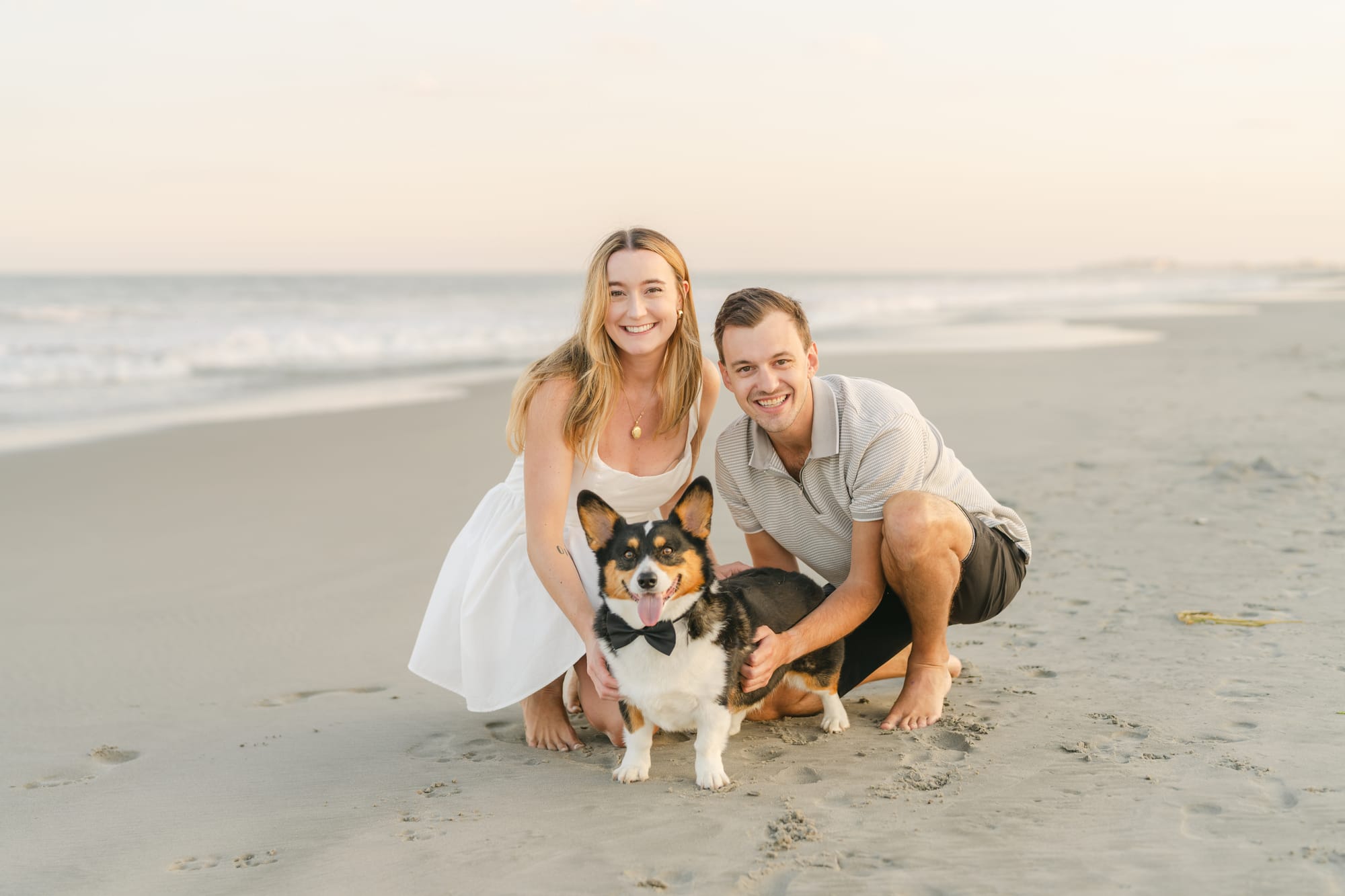 Kneeling in the sand with the corgi