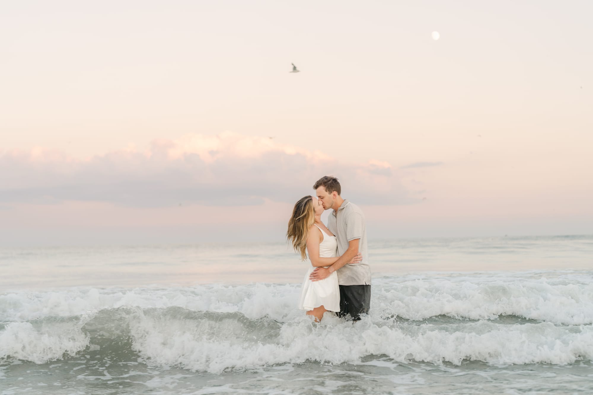A kiss standing in the breaking waves
