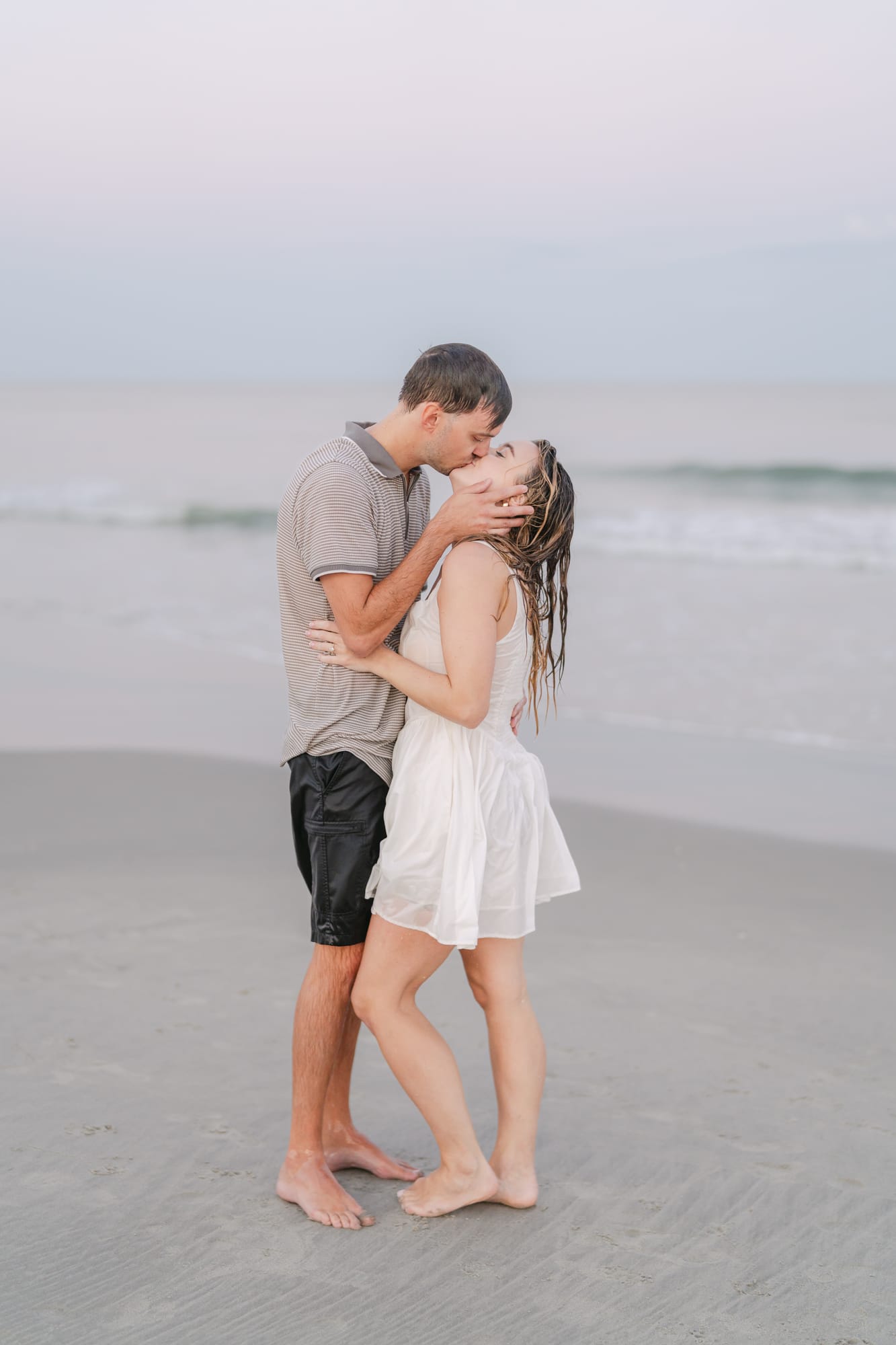 A kiss as a wave rolls in